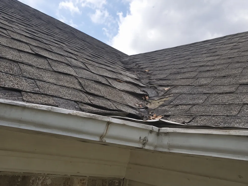 Sagging, uneven roofline above a gutter
