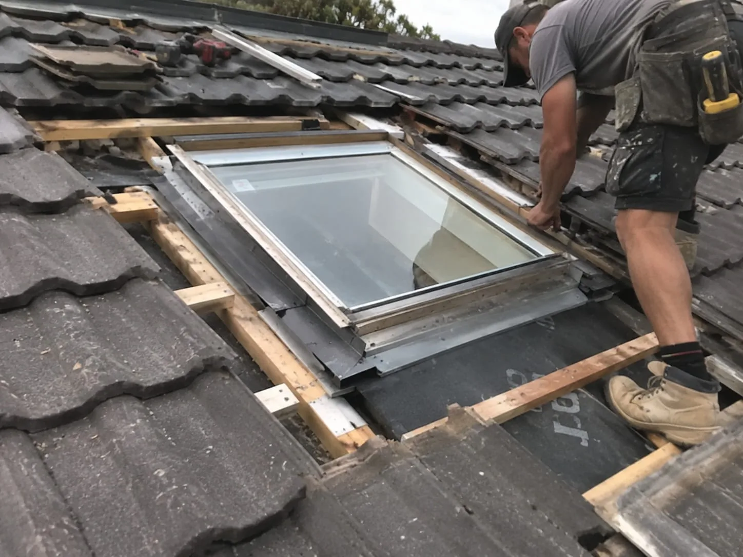 Roofer repairing a residential roof in West Auckland