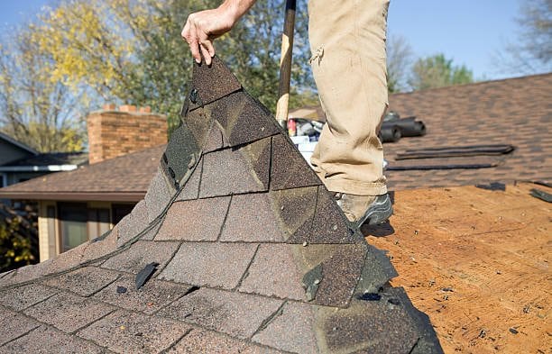 Roof shingles being checked during repair